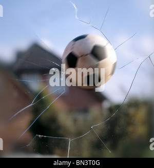 Soccer ball hitting window glass Stock Photo