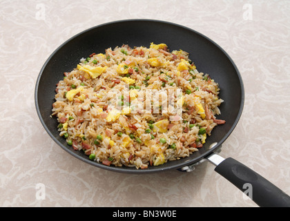 skillet pan full of colorful ham fried rice on table Stock Photo