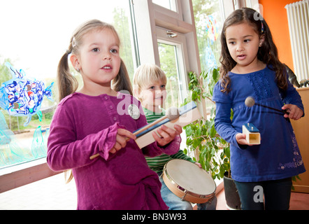 Children making music in a kindergarten Stock Photo