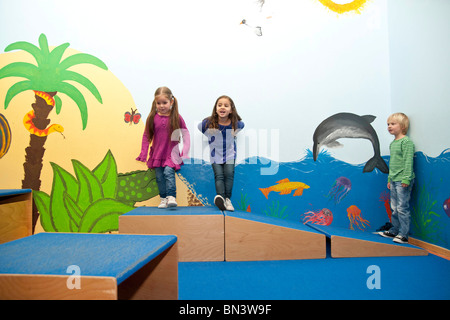 Children standing on boxes in a kindergarten Stock Photo