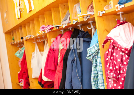 Clothes hanging in the cloakroom of a kindergarten Stock Photo