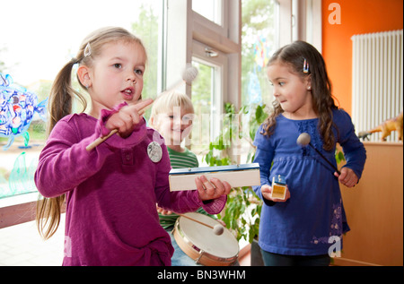 Children making music in a kindergarten Stock Photo