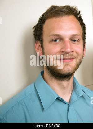 Portrait close-up young man beard wearing blue shirt Stock Photo