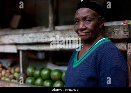 Portrait of a woman selling fruit on a roadside stand in Jamaica Stock Photo