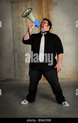 Man using megaphone over grunge industrial environment Stock Photo