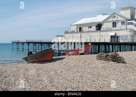 Fishing boats and lobster pots on shingle beach by the pier at Bognor Regis. West Sussex. England Stock Photo
