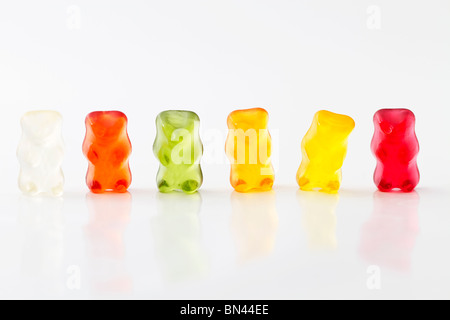 colorful row of jelly bears on white background Stock Photo