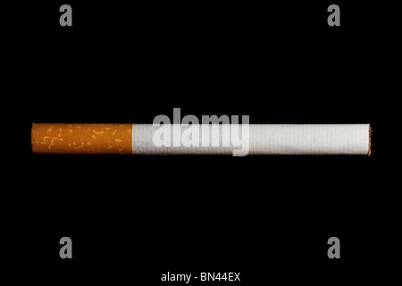 one cigarette with filter isolated on black background Stock Photo