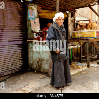 old man outside his shop , side street  near souk goma (friday market),  Southern Cemeteries, Khalifa district ,cairo,egypt Stock Photo
