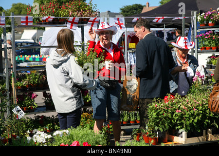 Selecting plants for the garden from a bedding plant stall in Dorchester market Stock Photo