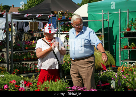 Selecting plants for the garden from a bedding plant stall in Dorchester market Stock Photo