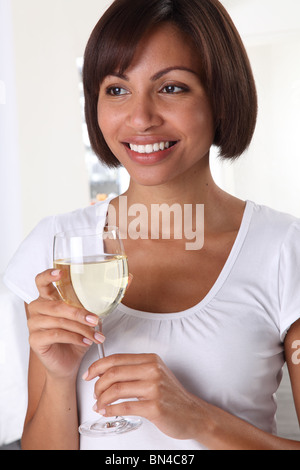 WOMAN HOLDING A GLASS OF WHITE WINE Stock Photo