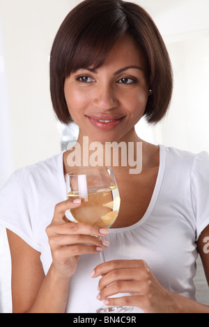 WOMAN HOLDING A GLASS OF WHITE WINE Stock Photo