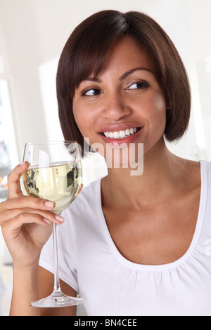 WOMAN HOLDING A GLASS OF WHITE WINE Stock Photo