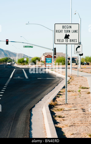 A bike lane is indicated by painted markings on a city street. A right turn lane is on the right. Stock Photo