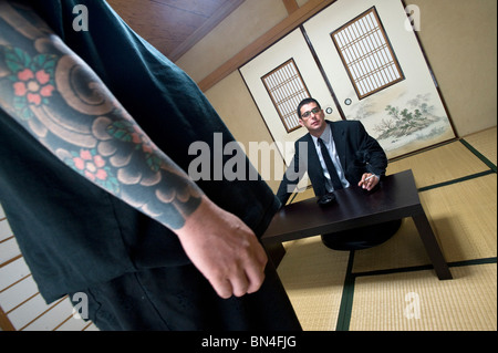 Jake Adelstein, author of Tokyo Vice, sits with his bodyguard, a former yakuza member Stock Photo