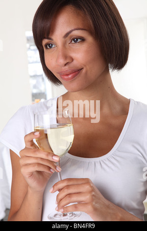 WOMAN HOLDING A GLASS OF WHITE WINE Stock Photo