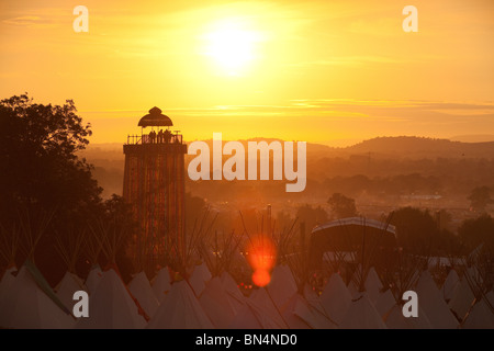 Sunset at the Glastonbury festival 2010, Photographed from Pennard Hill looking at the Park stage arena and ribbon tower Stock Photo