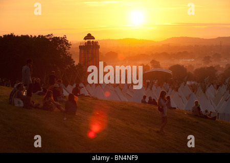 Sunset at the Glastonbury festival 2010, Photographed from Pennard Hill looking at the Park stage arena and ribbon tower Stock Photo