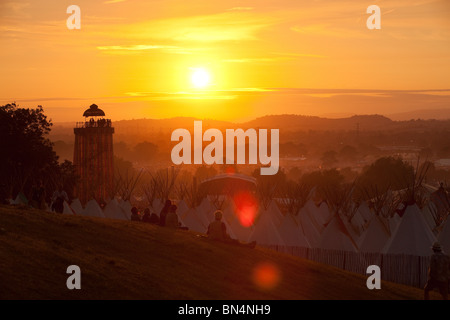 Sunset at the Glastonbury festival 2010, Photographed from Pennard Hill looking at the Park stage arena and ribbon tower Stock Photo