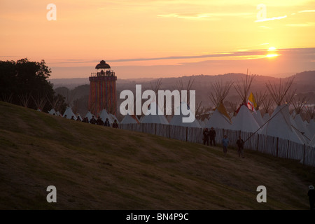 Sunset at the Glastonbury festival 2010, Photographed from Pennard Hill looking at the Park stage arena and ribbon tower Stock Photo