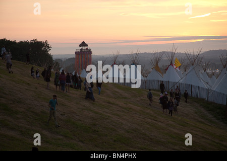 Sunset at the Glastonbury festival 2010, Photographed from Pennard Hill looking at the Park stage arena and ribbon tower Stock Photo