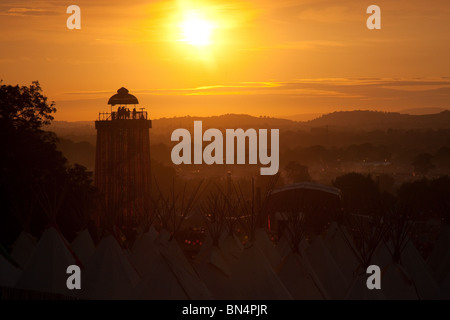 Sunset at the Glastonbury festival 2010, Photographed from Pennard Hill looking at the Park stage arena and ribbon tower Stock Photo