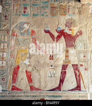 Bas relief picture from the temple of Hatshepsut, Luxor, Egypt, the pharaoh (on the right) making offerings to the God Horus Stock Photo