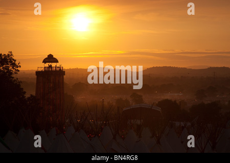 Sunset at the Glastonbury festival 2010, Photographed from Pennard Hill looking at the Park stage arena and ribbon tower Stock Photo