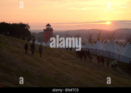 Sunset at the Glastonbury festival 2010, Photographed from Pennard Hill looking at the Park stage arena and ribbon tower Stock Photo