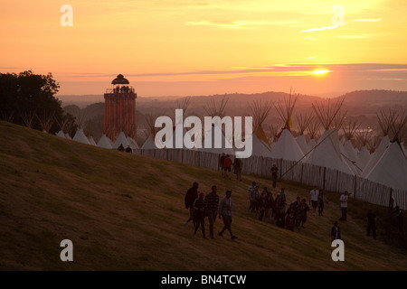 Sunset at the Glastonbury festival 2010, Photographed from Pennard Hill looking at the Park stage arena and ribbon tower Stock Photo