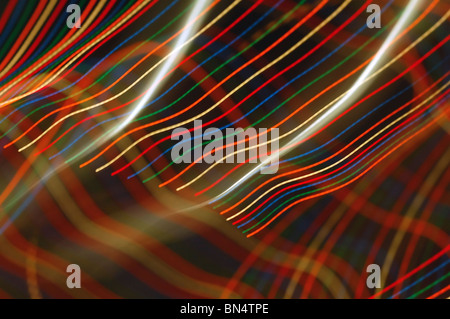 A long exposure of multi-colored lights creating thick lines. Stock Photo