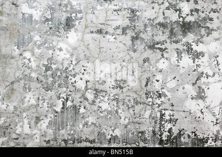 The gray concrete wall covered with stains and cracks - background Stock Photo