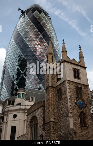 View of 'The Gerkin' building in London behind old church Stock Photo