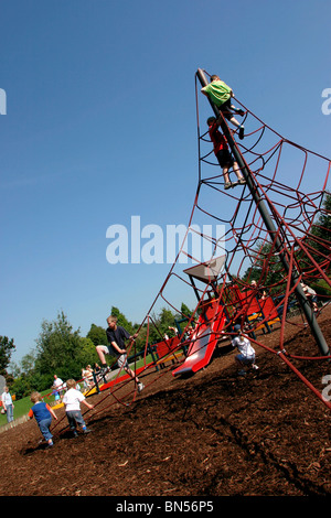 England, Cheshire, Stockport, Cheadle, Bruntwood Park, award-winning children's play area playing on climbing net Stock Photo