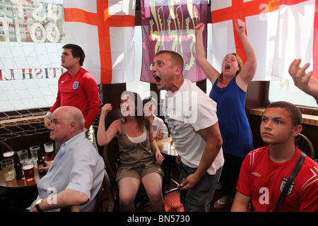 England football fans watching the 2010 World Cup game against Germany in a London pub Stock Photo