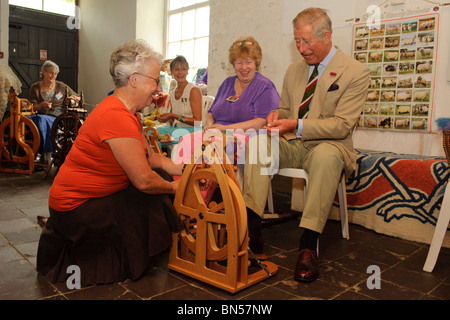 The Prince of Wales visiting the Welsh Woolen Museum, Drefach Felindre, Carmarthenshire, June 28 2010, being shown how to spin Stock Photo