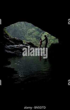 Tourists visit a cave at the Misol Ha waterfall in Salto de Agua, Chiapas, Mexico. Stock Photo