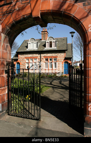 England, Cheshire, Stockport, Heaton Moor, Charity, Victorian Ainsworth Almshouses in Green Lane through arched gateway Stock Photo