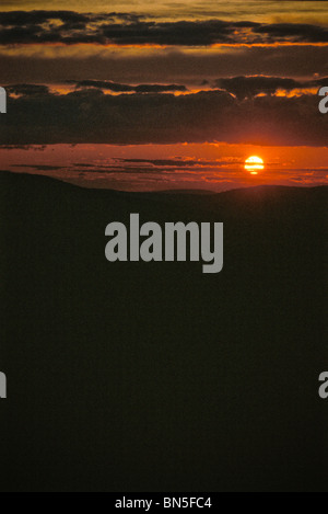Beautiful blazing sunset landscape at over the meadow and orange sky ...