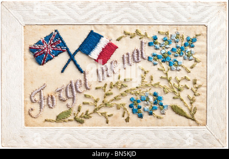 Forget Me Not / Forget Me Nots - early 1900s embroidered postcard depicting French and British flags and flowers. Stock Photo