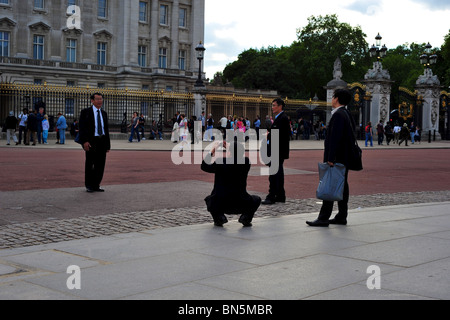 Photographing each other in front of Buckingham Palace Stock Photo