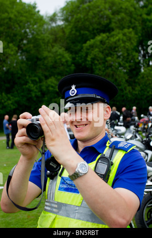 Police Taking Camera Policeman with camera taking photos Stock Photo - Alamy