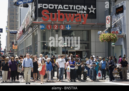 Busy crosswalk at 7th Ave, and 42nd St. in the Times Square area of NYC. Stock Photo