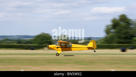 1959 Piper L-18C Super Cub light aircraft, taking off from an aerodrome in Kent, UK. Stock Photo