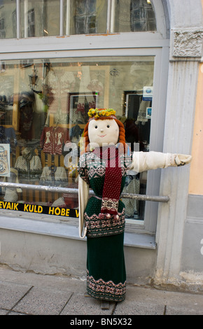 A life size doll dressed in the stores goods for advertisement pointing to the entrance in Tallinn Estonia. Stock Photo
