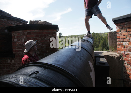 Tourists climb the old Russian fortress Notvikstornet near Bomarsund on the Åland archipelago between Finland and Sweden Stock Photo