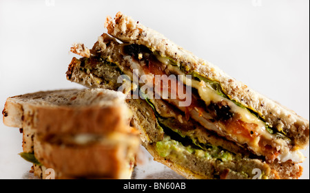 Ultimate club sandwich against white background with one sideways showing fillings and bread clearly. Healthy meal especially for breakfast or lunch Stock Photo