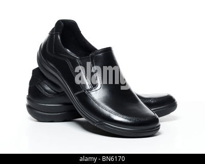 The pair of black leather shoes on a black background Stock Photo - Alamy