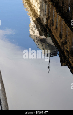 Reflection of rain clouds in the puddle Stock Photo - Alamy
